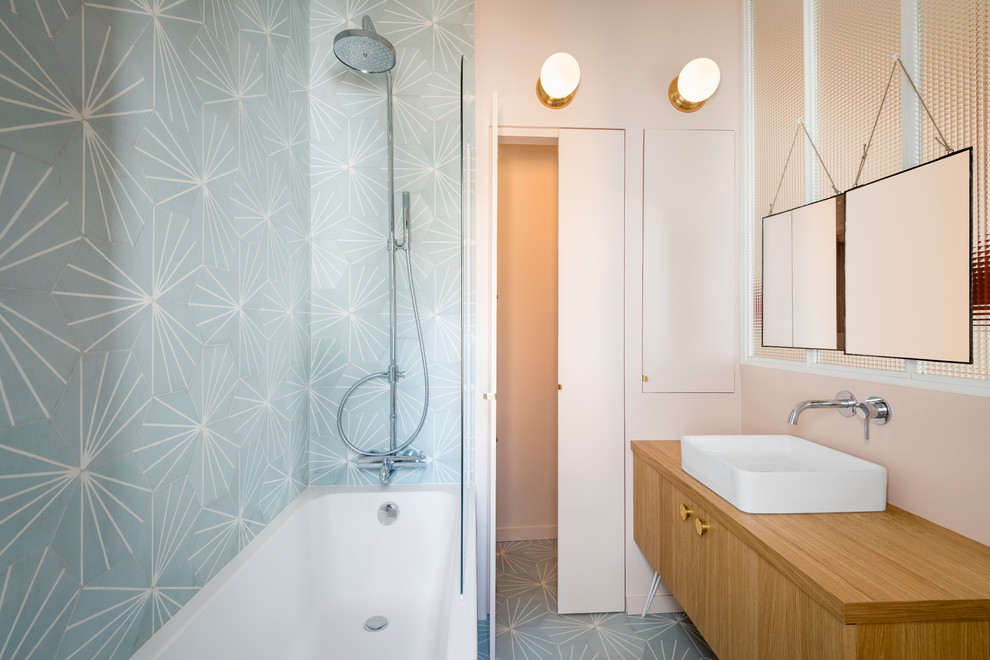 Inspiration för små badrum, med blå kakel, cementkakel, rosa väggar, cementgolv, ett nedsänkt handfat, träbänkskiva och blått golv