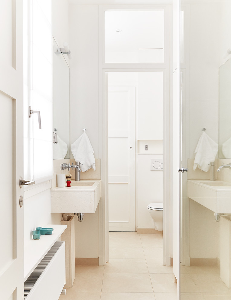 Bathroom - scandinavian beige tile bathroom idea in Paris with a wall-mount sink and white walls