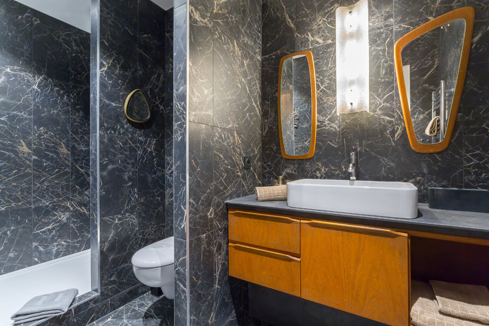 Inspiration for a 1950s 3/4 black and white tile and gray tile black floor bathroom remodel in Lyon with flat-panel cabinets, medium tone wood cabinets, a wall-mount toilet, a vessel sink and gray countertops