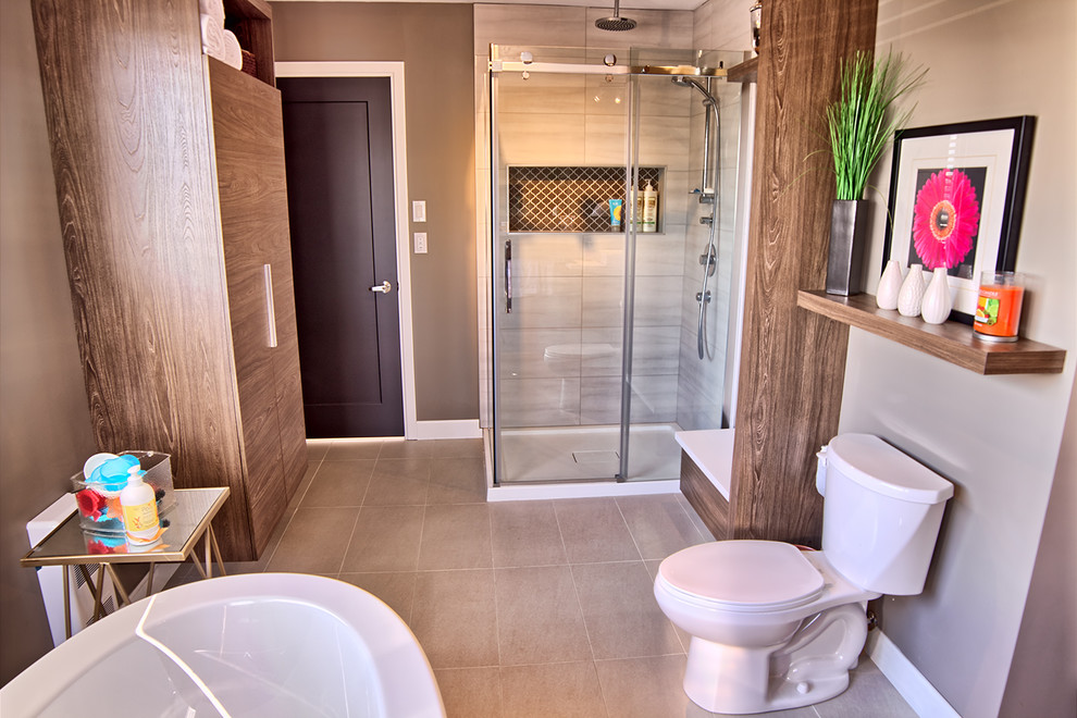 Photo of a large contemporary ensuite bathroom in Other with a trough sink, quartz worktops, a freestanding bath, a double shower, a two-piece toilet, beige tiles, ceramic tiles, beige walls and ceramic flooring.
