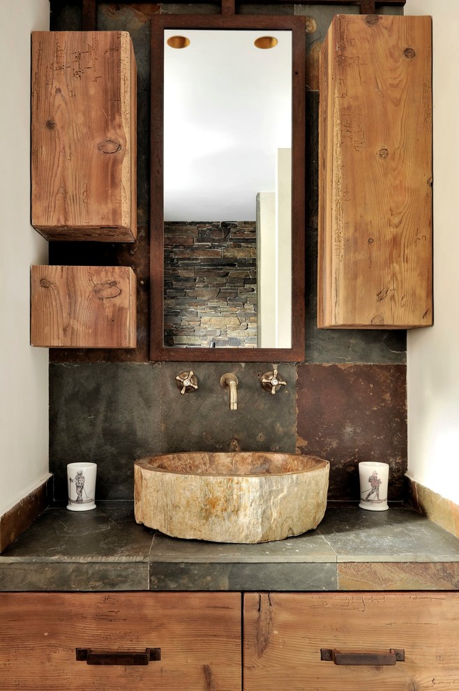 Medium sized rustic ensuite bathroom in Lyon with flat-panel cabinets, distressed cabinets, grey tiles, white walls, a vessel sink and stone tiles.
