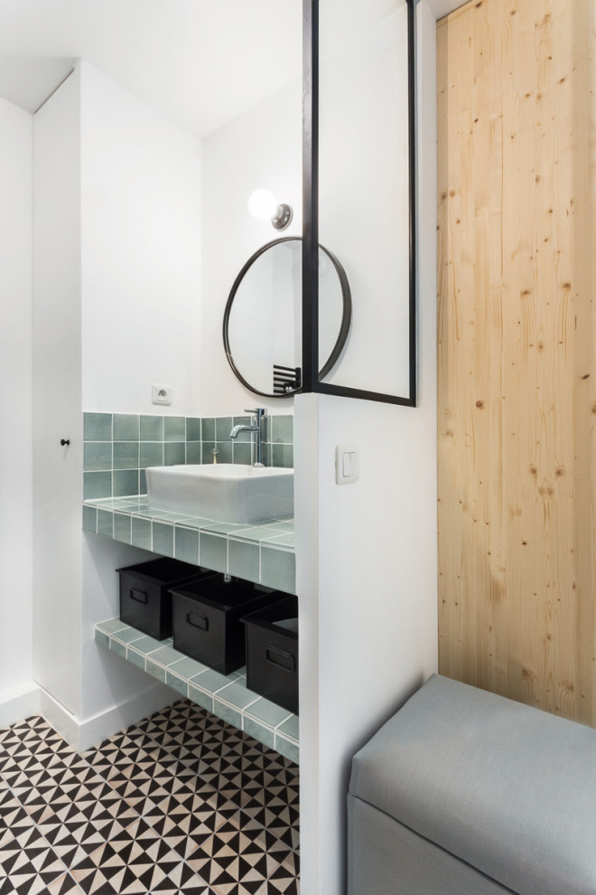 Inspiration for a small modern shower room bathroom in Marseille with louvered cabinets, white cabinets, a built-in shower, ceramic tiles, white walls, ceramic flooring, a built-in sink, tiled worktops, black floors, a hinged door, a single sink and a built in vanity unit.