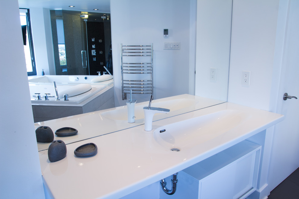 Contemporary ensuite bathroom in Montreal with flat-panel cabinets, white cabinets, a built-in bath, a double shower, a two-piece toilet, grey tiles, mosaic tiles, white walls, porcelain flooring, an integrated sink, black floors and a hinged door.