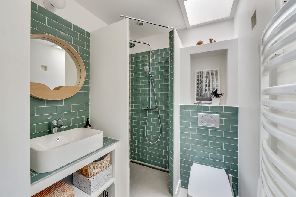 Photo of a contemporary shower room bathroom in Paris with open cabinets, a corner shower, a wall mounted toilet, green tiles, metro tiles, white walls, a vessel sink, beige floors, an open shower and turquoise worktops.