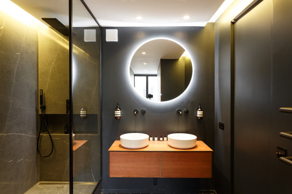 Design ideas for a medium sized contemporary ensuite bathroom in Other with beaded cabinets, beige cabinets, a built-in shower, black tiles, marble tiles, black walls, ceramic flooring, a vessel sink, wooden worktops, black floors, an open shower and beige worktops.