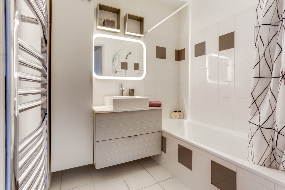 Idées déco pour une petite salle de bain principale moderne avec un placard à porte affleurante, des portes de placard blanches, un carrelage blanc, un mur blanc, un sol blanc, une baignoire encastrée, un sol en carrelage de céramique, une vasque, un plan de toilette en stratifié et un plan de toilette blanc.