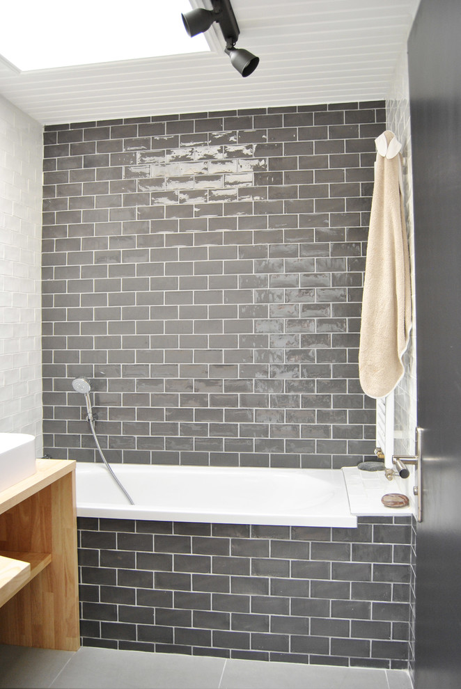 Design ideas for a medium sized contemporary family bathroom in Lille with a submerged bath, grey tiles, ceramic tiles, grey walls, a built-in sink, wooden worktops and grey floors.