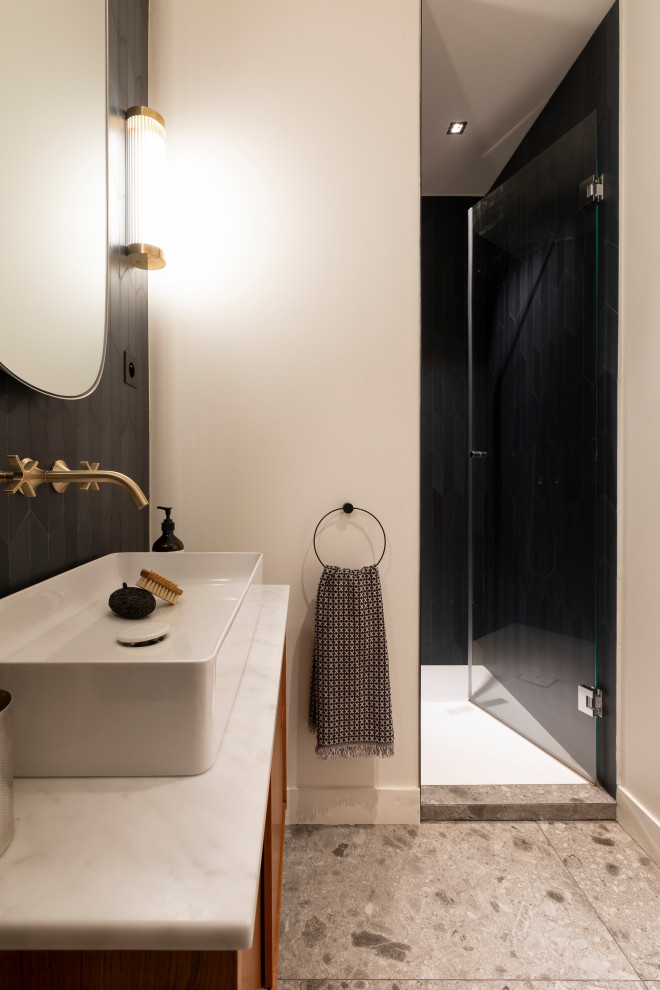 This is an example of a medium sized contemporary ensuite bathroom in Paris with blue tiles, ceramic tiles, a built-in sink and marble worktops.