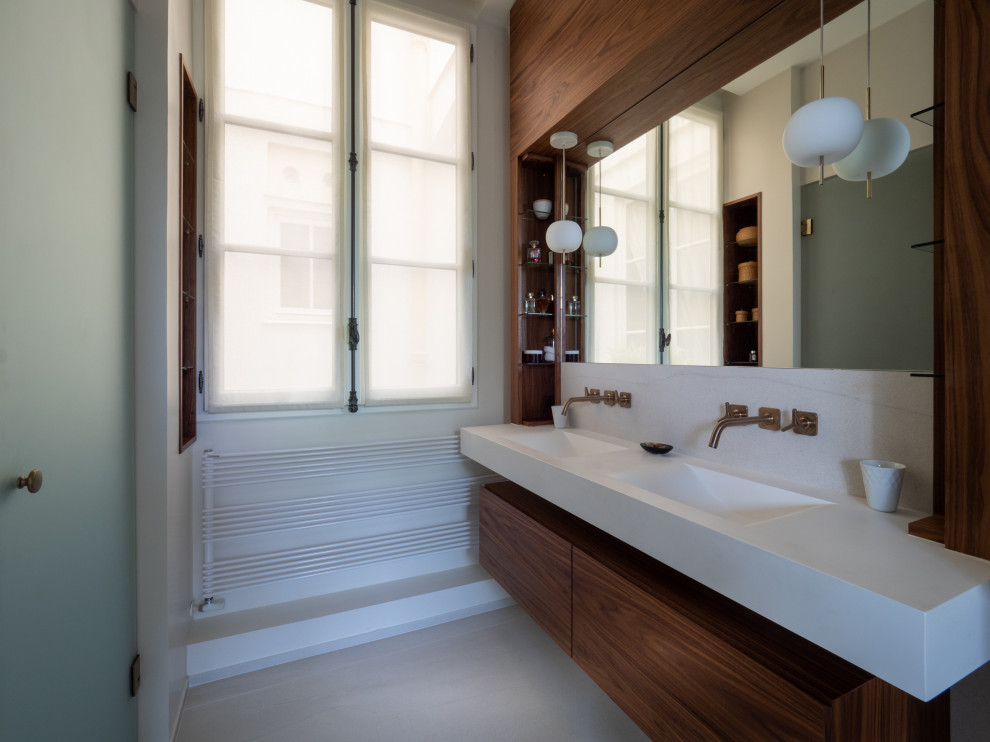 Aménagement d'une salle de bain contemporaine en bois brun avec un placard à porte plane, un lavabo intégré, un sol gris, un plan de toilette blanc, meuble double vasque et meuble-lavabo suspendu.