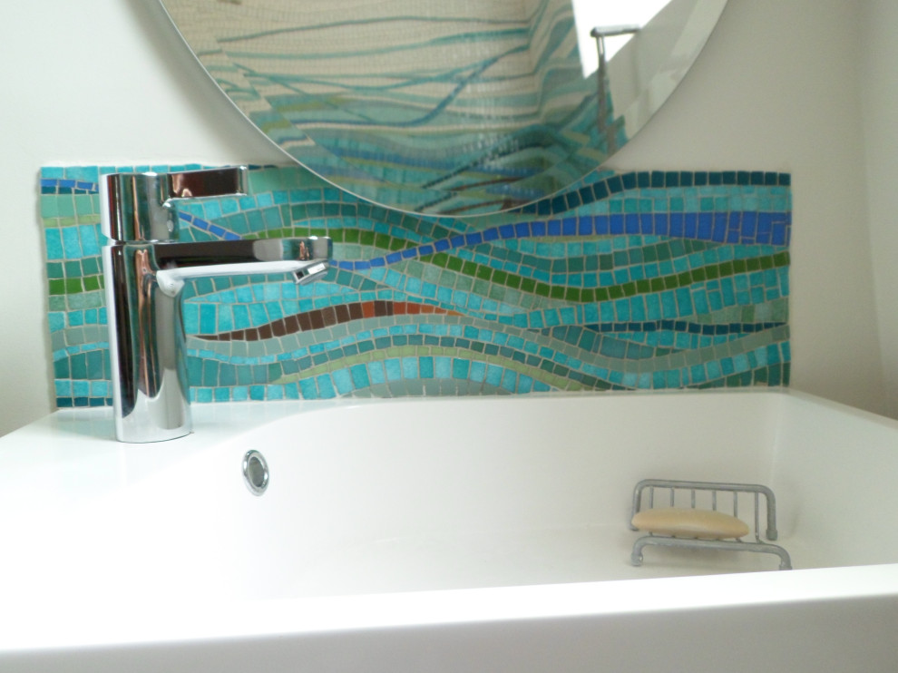 Immagine di una stanza da bagno american style con piastrelle a mosaico, pareti blu, pavimento con piastrelle a mosaico e top in vetro