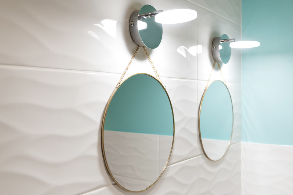 Bild på ett mellanstort skandinaviskt en-suite badrum, med luckor med profilerade fronter, skåp i ljust trä, ett hörnbadkar, vit kakel, keramikplattor, blå väggar, klinkergolv i porslin, ett väggmonterat handfat och vitt golv