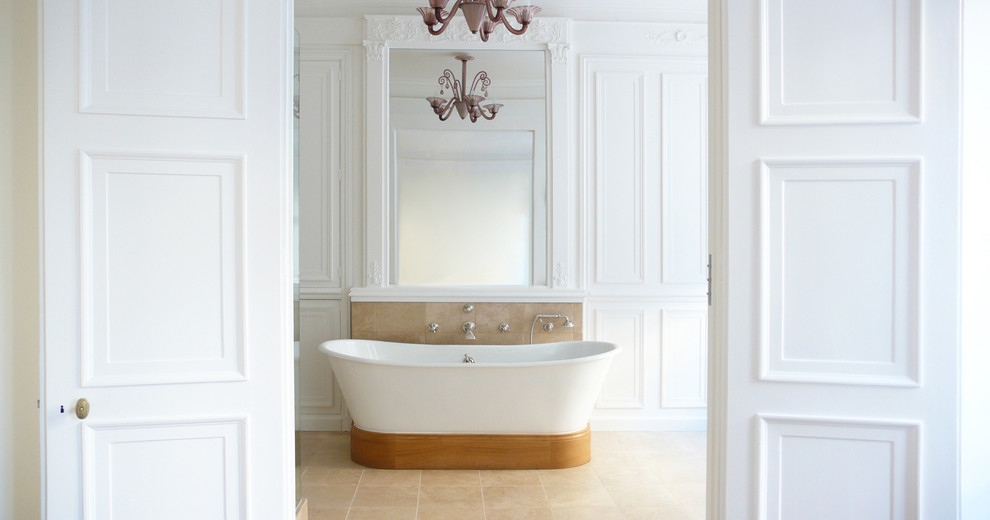 Immagine di una grande stanza da bagno padronale tradizionale con vasca freestanding, pareti bianche e pavimento in travertino