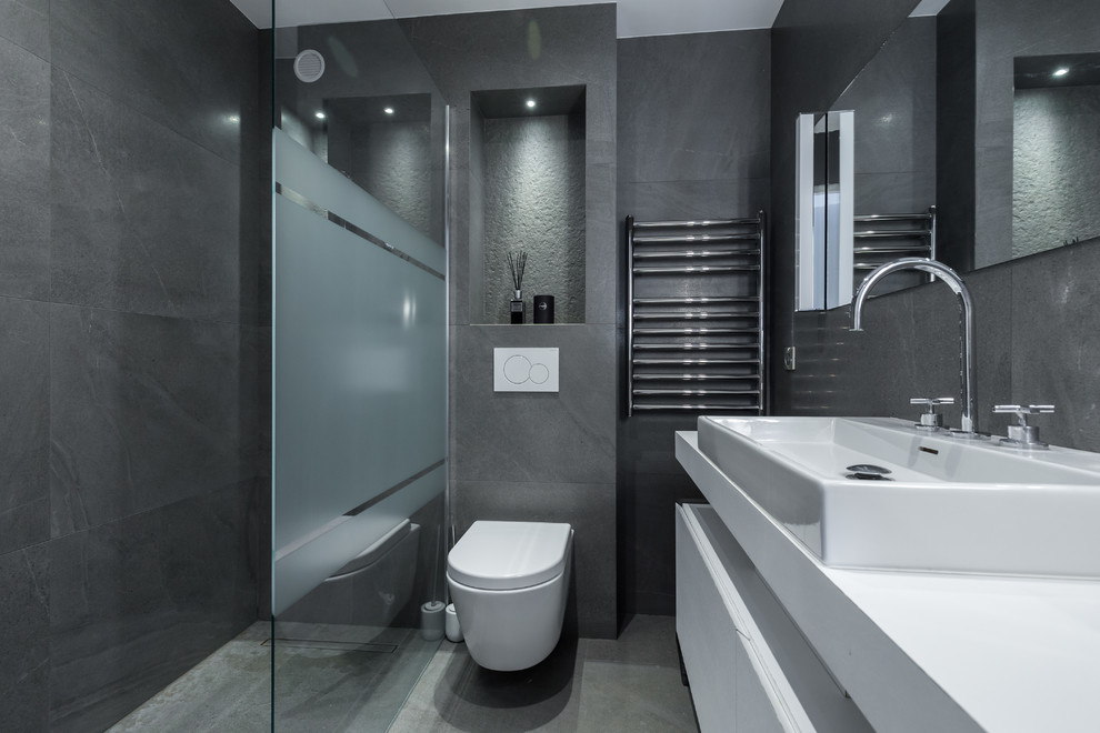 Small trendy gray tile gray floor walk-in shower photo in Nice with a wall-mount toilet, gray walls, a console sink and tile countertops