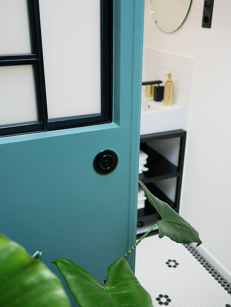 This is an example of a small modern shower room bathroom in Paris with a built-in shower, a wall mounted toilet, white tiles, mosaic tiles, white walls, mosaic tile flooring, a vessel sink, stainless steel worktops, white floors, a shower curtain, black worktops, a single sink and a freestanding vanity unit.