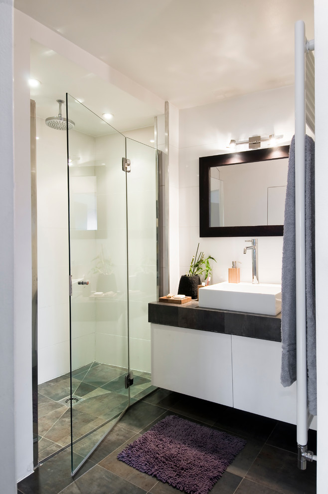 Walk-in shower - mid-sized contemporary 3/4 ceramic tile walk-in shower idea in Paris with white cabinets, white walls, a vessel sink and tile countertops