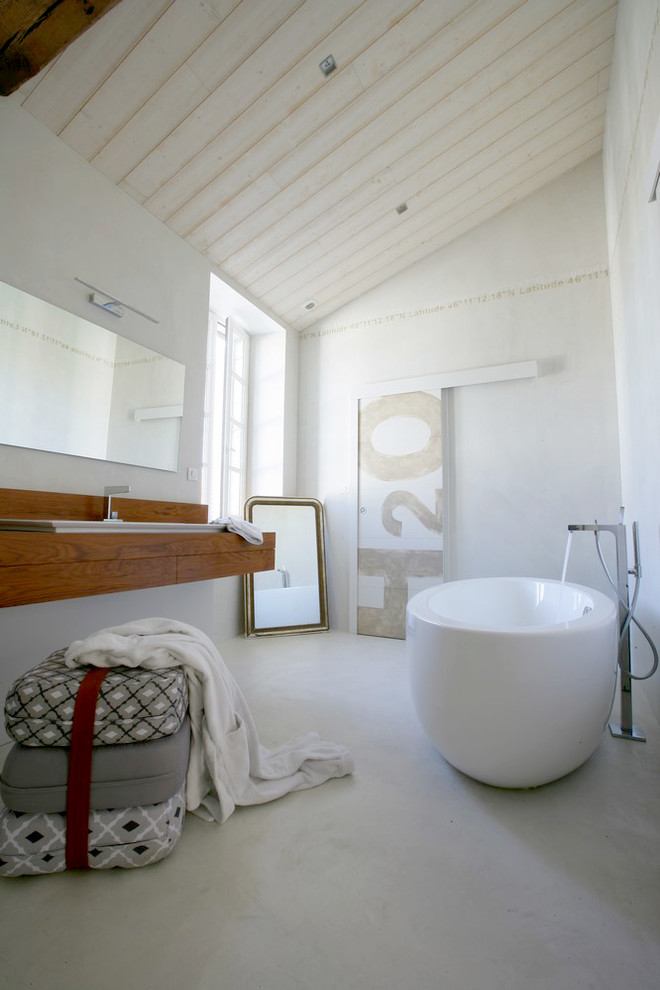 Cette image montre une salle de bain principale marine de taille moyenne avec un mur blanc, un lavabo posé, un plan de toilette en bois et un bain japonais.