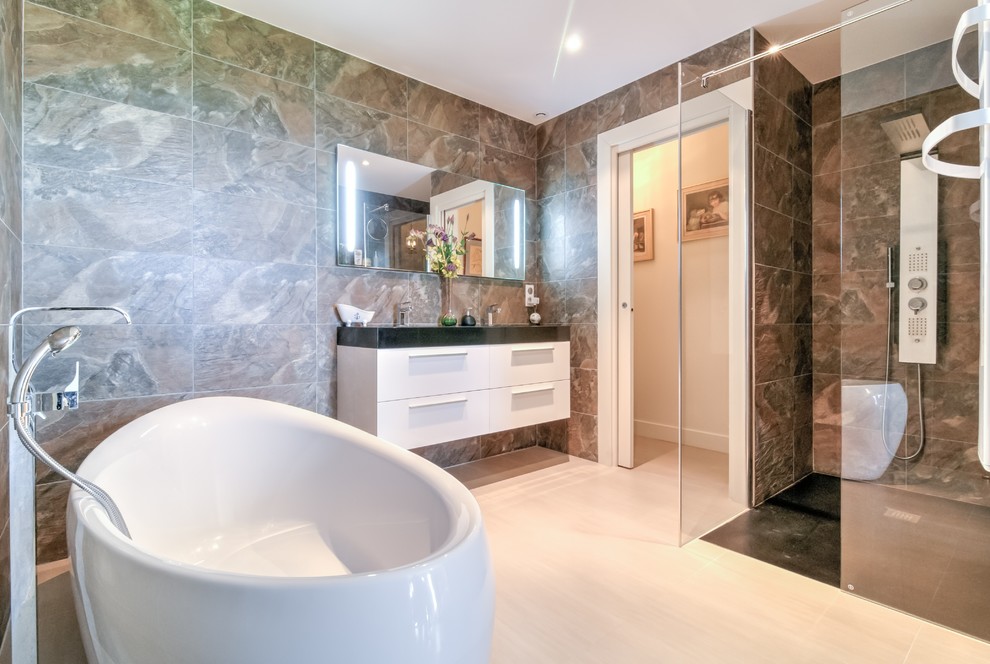 Idées déco pour une salle de bain principale moderne en bois clair de taille moyenne avec un lavabo encastré, un placard à porte vitrée, un plan de toilette en marbre, une baignoire indépendante, une douche ouverte, WC suspendus, un carrelage beige, un mur noir et un sol en bois brun.