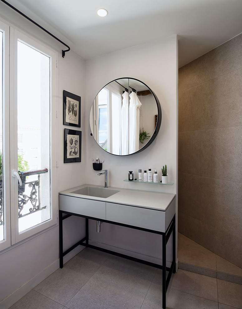 Design ideas for a medium sized contemporary ensuite bathroom in Paris with flat-panel cabinets, grey cabinets, grey tiles, grey walls, an integrated sink, grey floors and grey worktops.