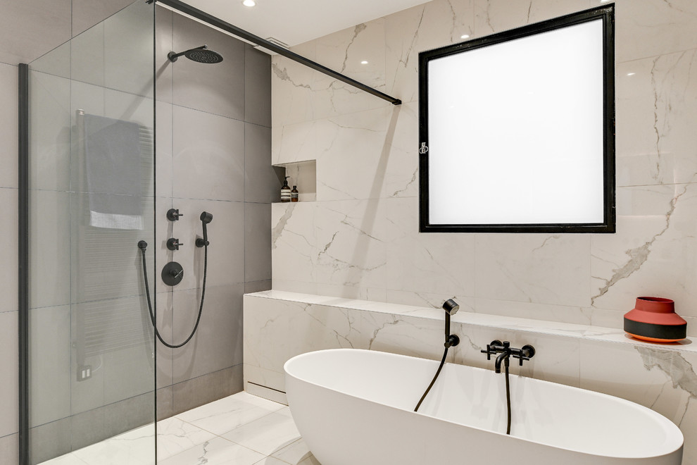 Design ideas for a large scandinavian ensuite bathroom in Paris with beaded cabinets, white cabinets, a freestanding bath, a built-in shower, grey tiles, ceramic tiles, white walls, marble flooring, a wall-mounted sink, solid surface worktops, white floors, an open shower and white worktops.