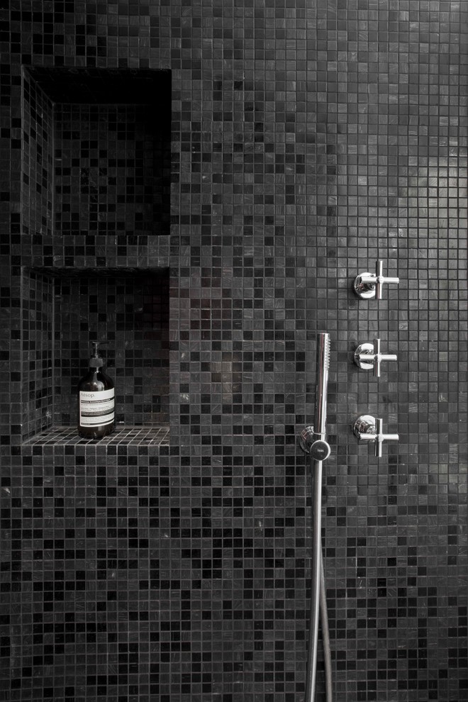 This is an example of a modern shower room bathroom in Paris with beaded cabinets, white cabinets, a built-in shower, a two-piece toilet, black tiles, mosaic tiles, white walls, mosaic tile flooring, an integrated sink and solid surface worktops.