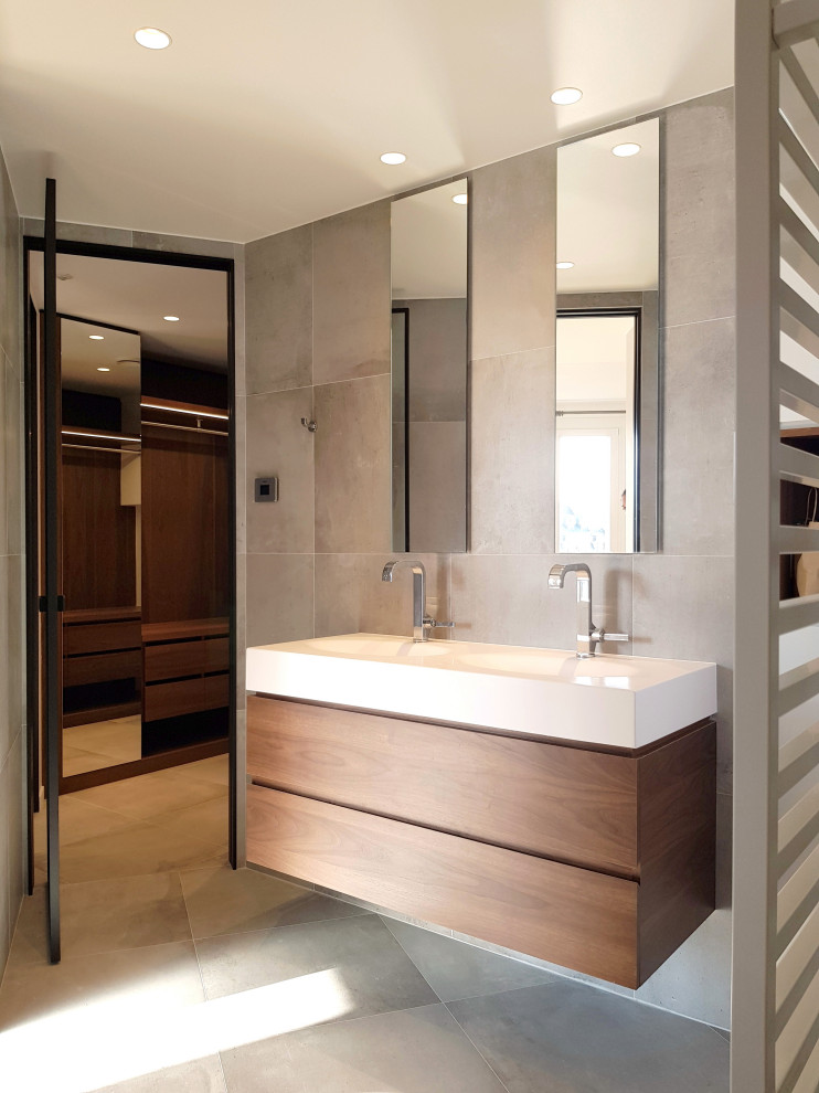 Bathroom - large contemporary 3/4 gray tile and porcelain tile porcelain tile, gray floor and double-sink bathroom idea in Paris with flat-panel cabinets, medium tone wood cabinets, an integrated sink, white countertops and a floating vanity