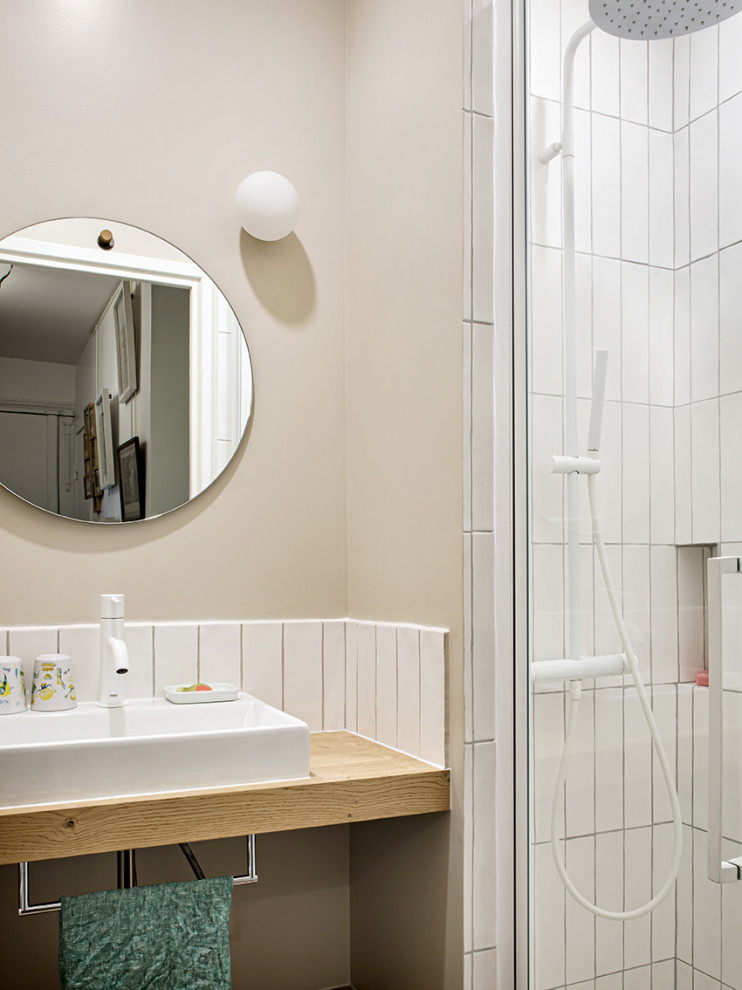 Medium sized contemporary shower room bathroom in Paris with open cabinets, light wood cabinets, an alcove shower, a two-piece toilet, white tiles, ceramic tiles, beige walls, light hardwood flooring, a console sink, wooden worktops, a hinged door, a single sink and a floating vanity unit.