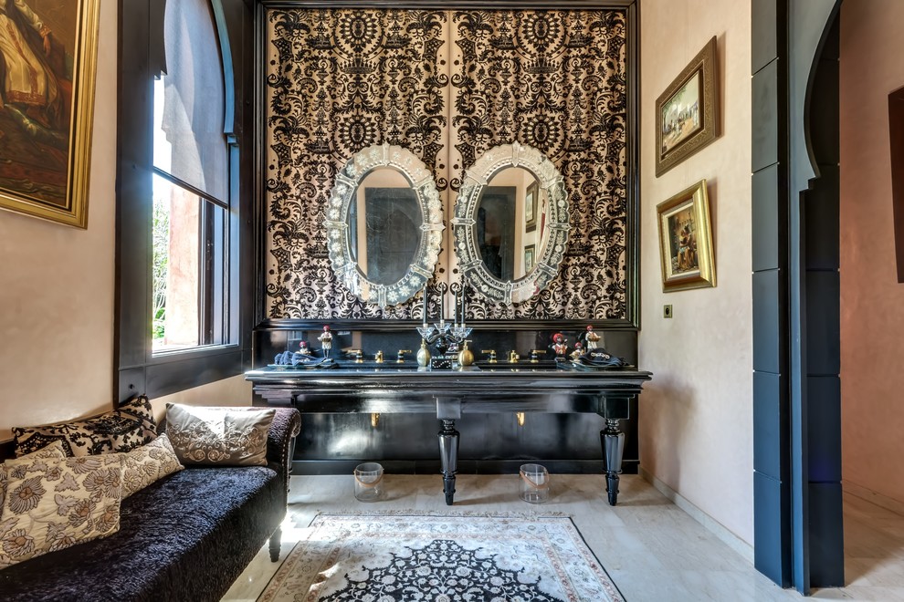 Diseño de cuarto de baño mediterráneo con puertas de armario negras, encimera de madera, baldosas y/o azulejos negros y paredes beige