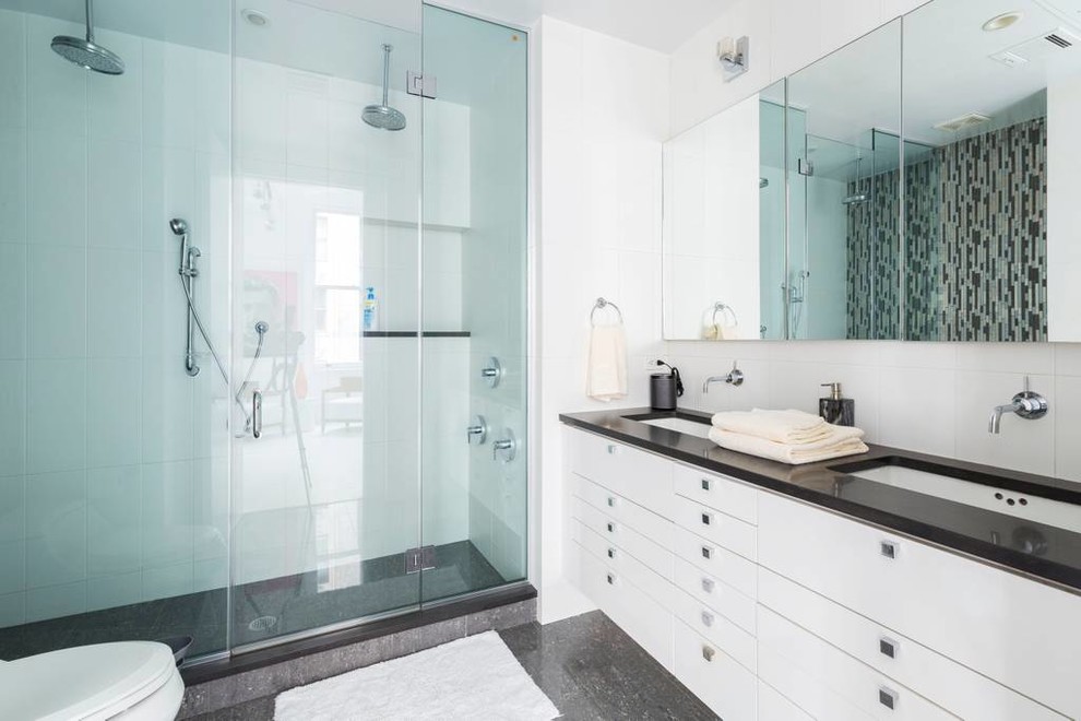 Inspiration for a large contemporary shower room bathroom in Paris with flat-panel cabinets, white cabinets, a double shower, a wall mounted toilet, beige tiles, white tiles, blue tiles, black tiles, mosaic tiles, white walls, marble flooring, a wall-mounted sink, marble worktops, grey floors, a sliding door and black worktops.