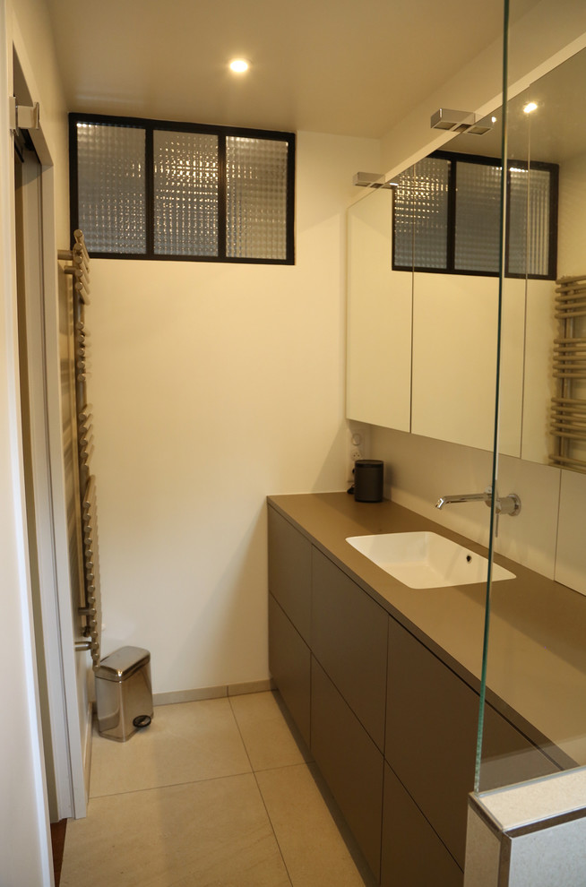Photo of a small contemporary ensuite bathroom in Other with beaded cabinets, brown cabinets, a built-in shower, beige tiles, stone slabs, white walls, a submerged sink, laminate worktops, beige floors, an open shower and brown worktops.