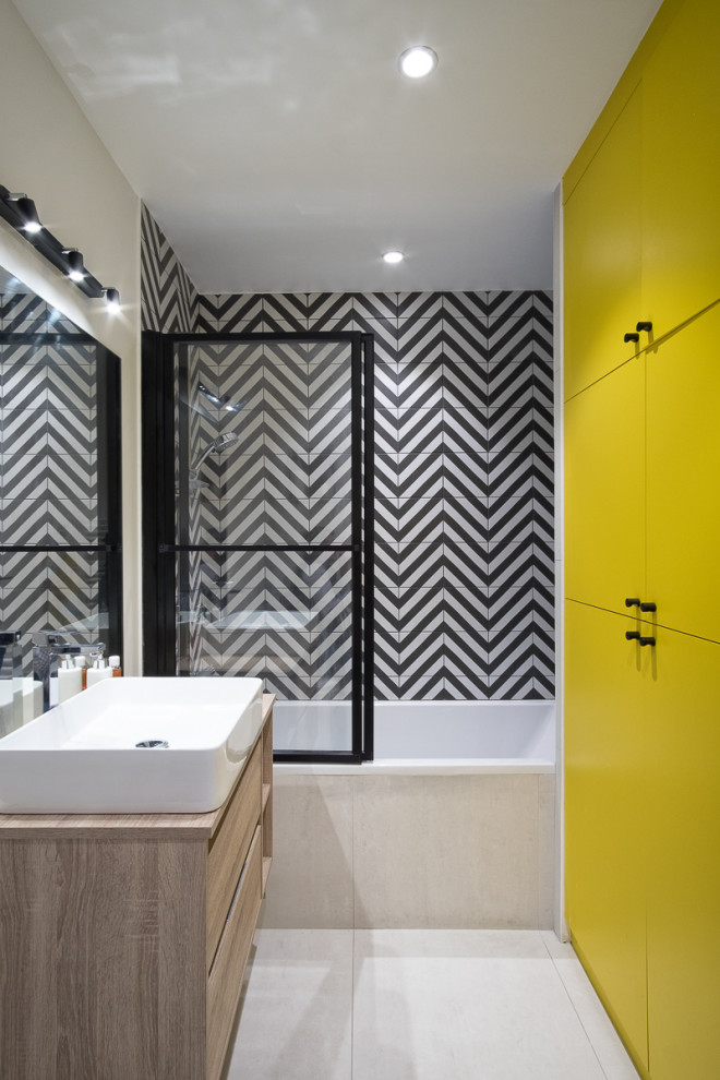 Inspiration for a medium sized contemporary shower room bathroom in Paris with flat-panel cabinets, light wood cabinets, an alcove bath, a shower/bath combination, black and white tiles, porcelain tiles, porcelain flooring, a vessel sink, wooden worktops, beige floors, a sliding door, beige worktops, a single sink and a floating vanity unit.