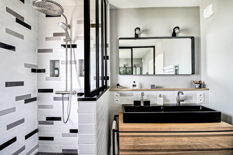 Example of a mid-sized urban 3/4 white tile and subway tile ceramic tile and gray floor walk-in shower design in Bordeaux with white walls, a trough sink and wood countertops