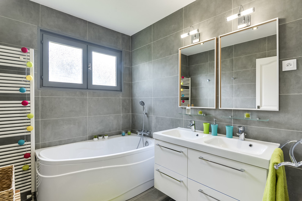 Example of a mid-sized trendy kids' gray tile and cement tile gray floor and cement tile floor bathroom design in Paris with gray walls, a console sink, beaded inset cabinets, white cabinets, a two-piece toilet and tile countertops