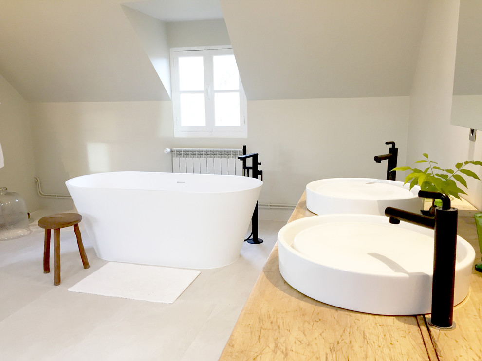 Idéer för mellanstora funkis badrum, med luckor med profilerade fronter, skåp i ljust trä, ett fristående badkar, en kantlös dusch, vita väggar, ett konsol handfat, grått golv, med dusch som är öppen och cementgolv