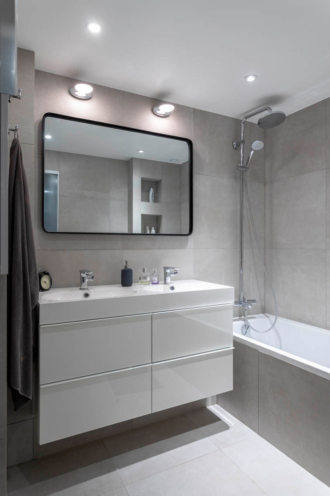 Exempel på ett mellanstort modernt vit vitt en-suite badrum, med vita skåp, ett undermonterat badkar, en dusch/badkar-kombination, beige kakel, keramikplattor, beige väggar, klinkergolv i keramik, ett avlångt handfat, beiget golv och med dusch som är öppen