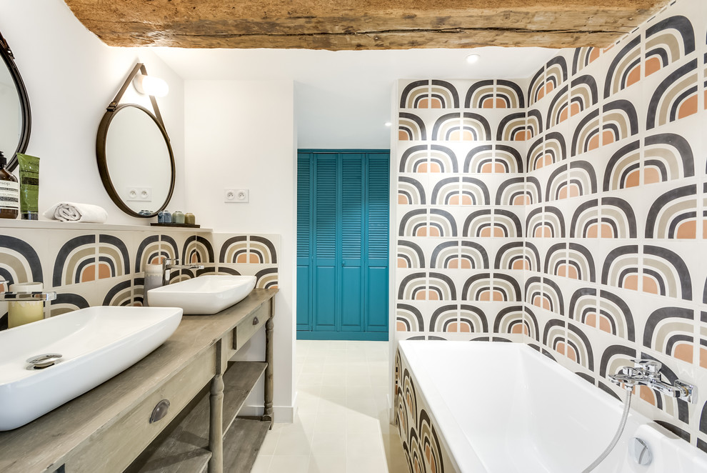 Photo of a large bohemian ensuite bathroom in Paris with louvered cabinets, blue cabinets, a built-in shower, a wall mounted toilet, cement tiles, white walls, cement flooring, a built-in sink and beige floors.