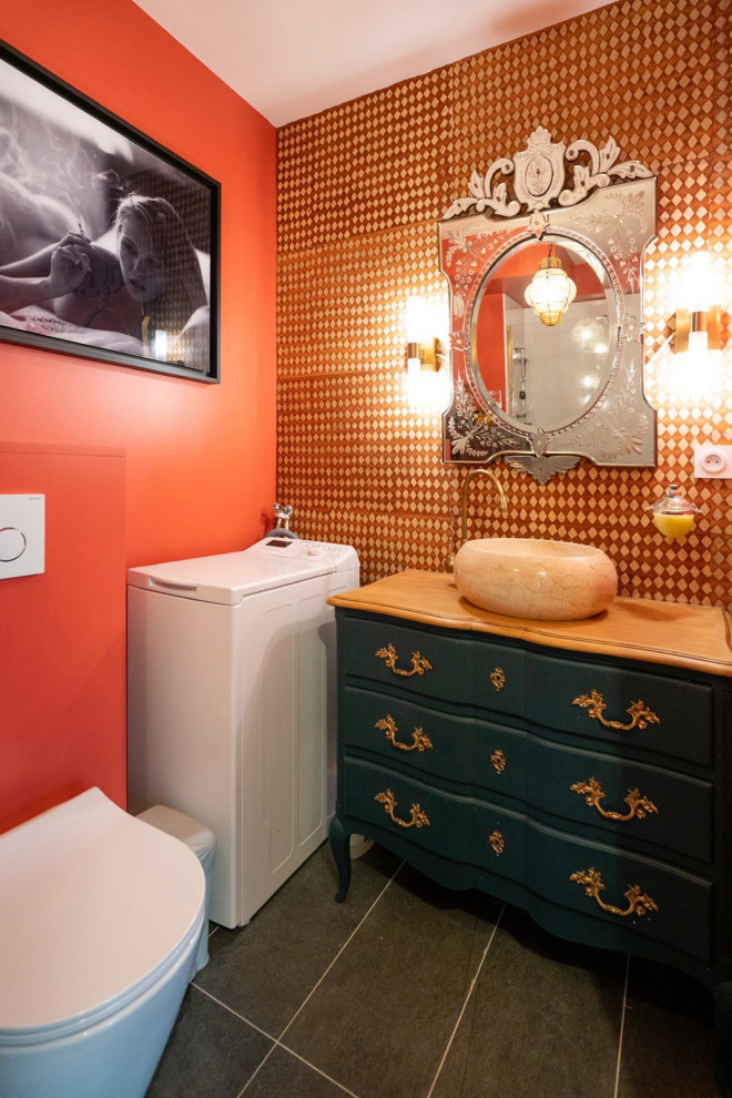 Inspiration for a mid-sized contemporary master cement tile floor, gray floor and single-sink bathroom remodel in Paris with a wall-mount toilet, orange walls, a pedestal sink and wood countertops