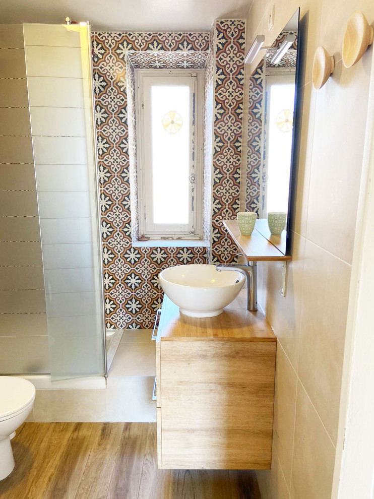 Small tuscan 3/4 multicolored tile and cement tile wood-look tile floor, brown floor and single-sink bathroom photo in Nice with light wood cabinets, a one-piece toilet, beige walls, a drop-in sink, wood countertops, beige countertops and a floating vanity