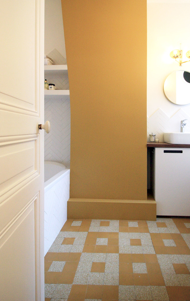 Inspiration för små moderna en-suite badrum, med luckor med profilerade fronter, vita skåp, ett undermonterat badkar, våtrum, vit kakel, stickkakel, gula väggar, cementgolv, ett konsol handfat, träbänkskiva, gult golv och med dusch som är öppen