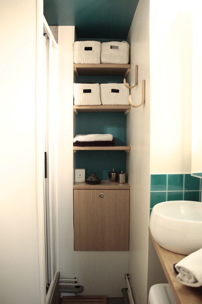 This is an example of a small industrial shower room bathroom in Nice with an alcove shower, a wall mounted toilet, green tiles, green walls, slate flooring, a vessel sink, wooden worktops, grey floors and a sliding door.