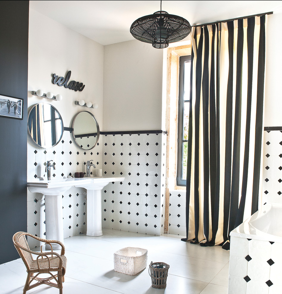 На фото: главная ванная комната среднего размера в современном стиле с раковиной с пьедесталом, накладной ванной, черно-белой плиткой и разноцветными стенами