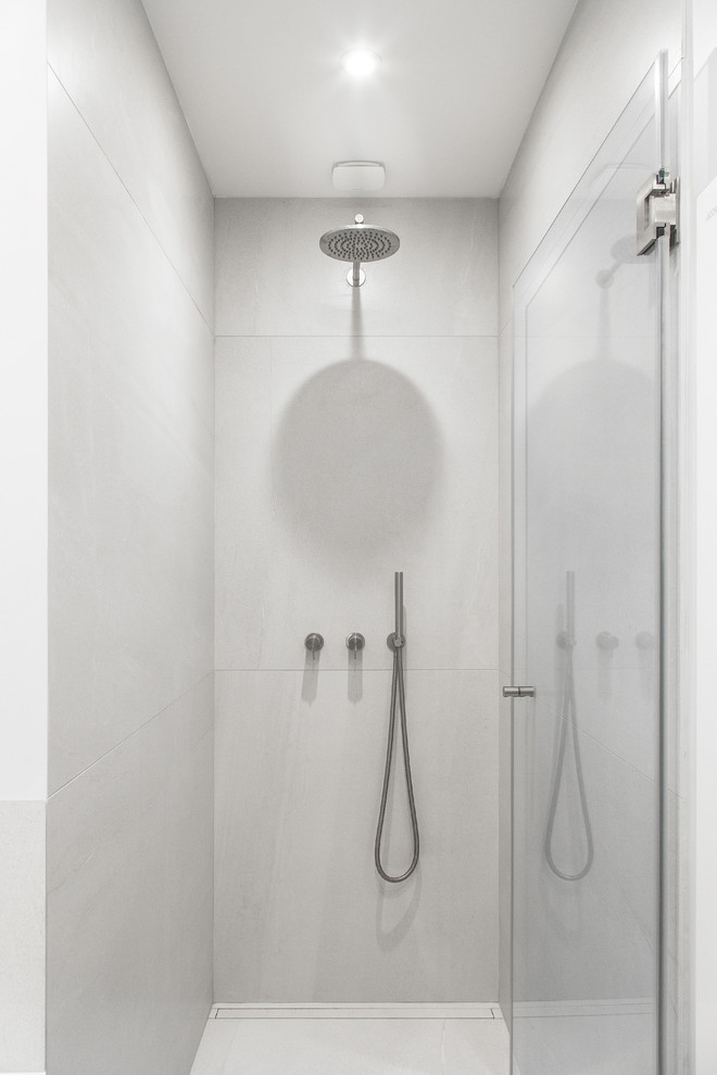Exempel på ett mellanstort nordiskt beige beige en-suite badrum, med ett undermonterat badkar, beige kakel, ett nedsänkt handfat, grått golv, släta luckor, skåp i ljust trä, en dusch/badkar-kombination, en vägghängd toalettstol, keramikplattor, beige väggar, cementgolv, träbänkskiva och med dusch som är öppen
