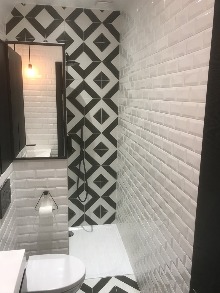 Idée de décoration pour une petite salle de bain principale design avec des portes de placard noires, une douche à l'italienne, WC suspendus, un carrelage blanc, un carrelage noir, un carrelage métro, un mur blanc, un sol en carrelage de céramique, un lavabo intégré, un plan de toilette en quartz, un sol blanc et un plan de toilette blanc.