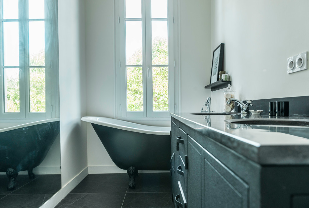 Design ideas for a small traditional ensuite bathroom in Bordeaux with black cabinets, a claw-foot bath, white tiles, white walls, marble flooring, a submerged sink, marble worktops, grey floors, black worktops, double sinks and a freestanding vanity unit.