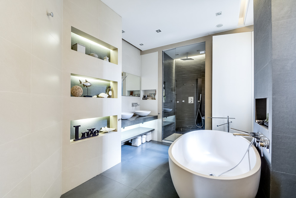 На фото: главная ванная комната среднего размера в стиле неоклассика (современная классика) с белыми фасадами, накладной ванной, душем без бортиков, белыми стенами, серой плиткой, цементной плиткой, бетонным полом и консольной раковиной с