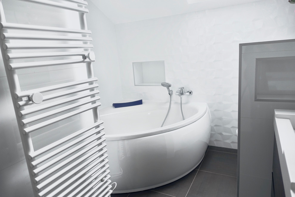 Idéer för ett litet modernt en-suite badrum, med släta luckor, bruna skåp, ett hörnbadkar, en dusch/badkar-kombination, en vägghängd toalettstol, vit kakel, porslinskakel, vita väggar, klinkergolv i keramik, ett konsol handfat, brunt golv och med dusch som är öppen