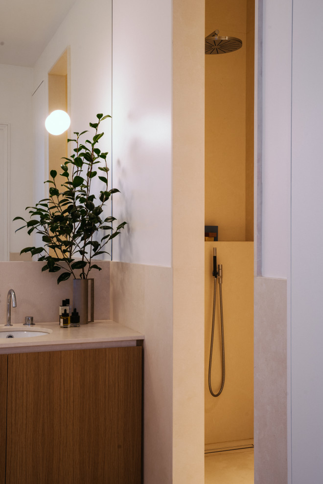 Example of a large transitional master beige tile terrazzo floor and beige floor bathroom design in Paris with beaded inset cabinets, brown cabinets, beige walls, an undermount sink, terrazzo countertops and beige countertops