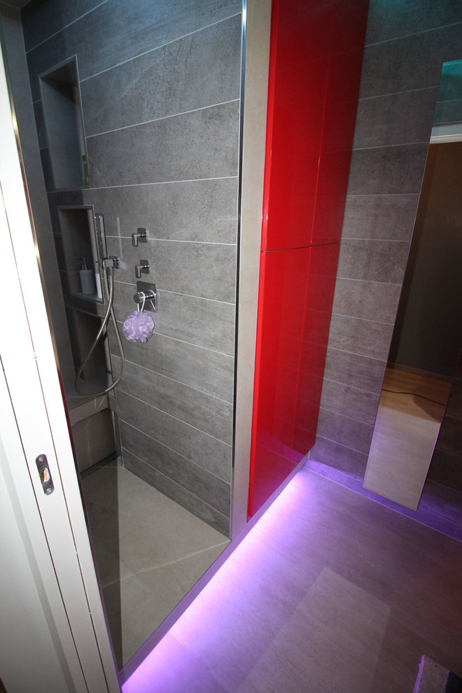 Design ideas for a small contemporary shower room bathroom in Paris with flat-panel cabinets, a built-in shower, grey tiles, grey walls, ceramic flooring and an integrated sink.