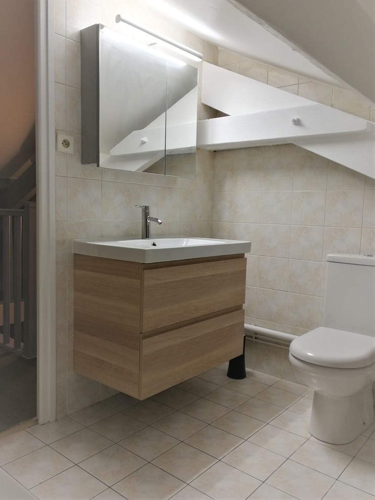 Inspiration for a small contemporary ensuite bathroom in Paris with light wood cabinets, a one-piece toilet, yellow tiles, ceramic tiles, yellow walls, ceramic flooring, a console sink, tiled worktops, yellow floors, flat-panel cabinets, a corner bath, white worktops, a single sink, a floating vanity unit and exposed beams.