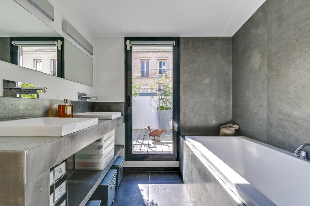 Exemple d'une salle de bain tendance de taille moyenne avec un placard sans porte, des portes de placard grises, un carrelage gris, carrelage en métal, un mur gris, un sol en ardoise et une vasque.