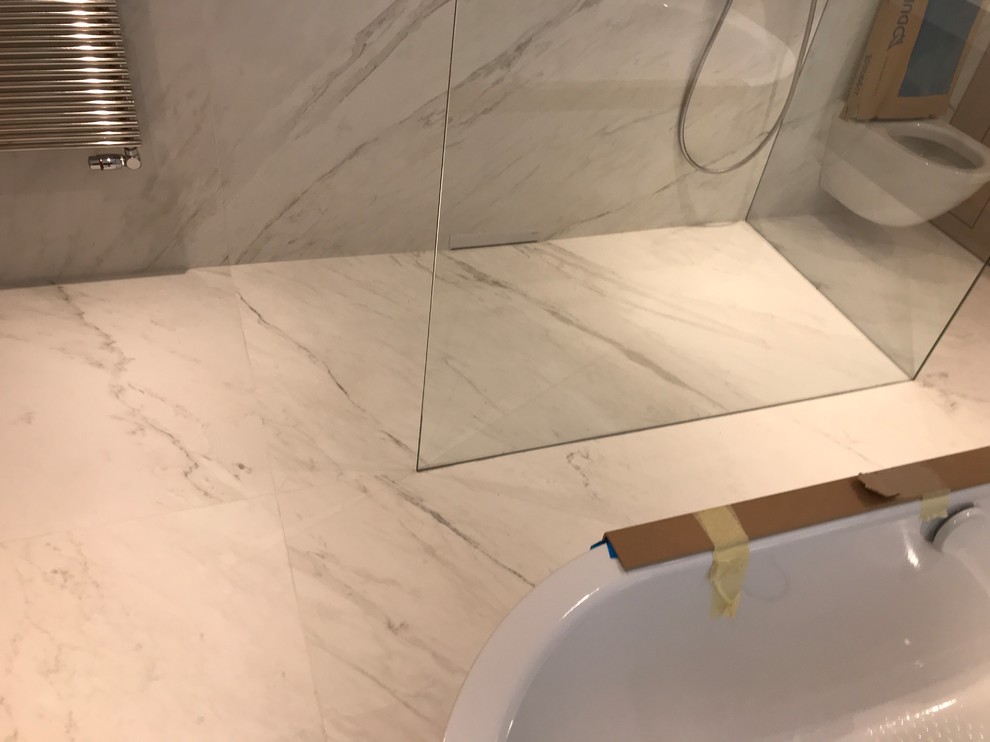 Photo of a large contemporary shower room bathroom in Paris with glass-front cabinets, a built-in bath, a built-in shower, a wall mounted toilet, white tiles, ceramic tiles, white walls, ceramic flooring, a built-in sink, tiled worktops, white floors and an open shower.